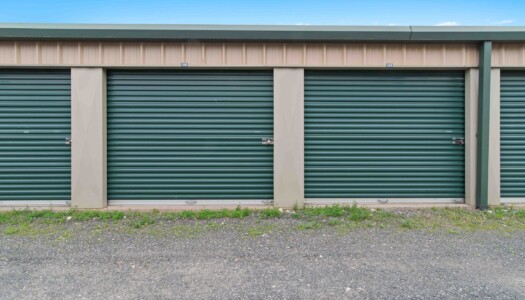 row of drive-up storage units at a fenced Pioneer Valley Storage facility in Belchertown, MA