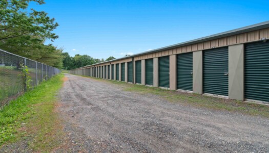 row of drive-up storage units at a fenced Pioneer Valley Storage facility in Belchertown, MA